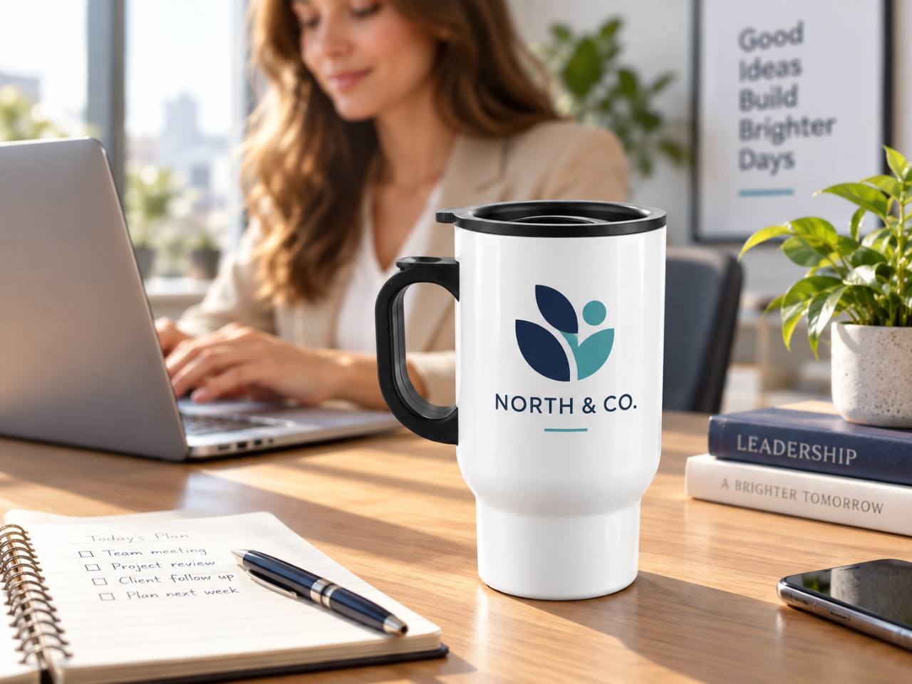 Representative white 14oz travel mug with a business logo in an office setting