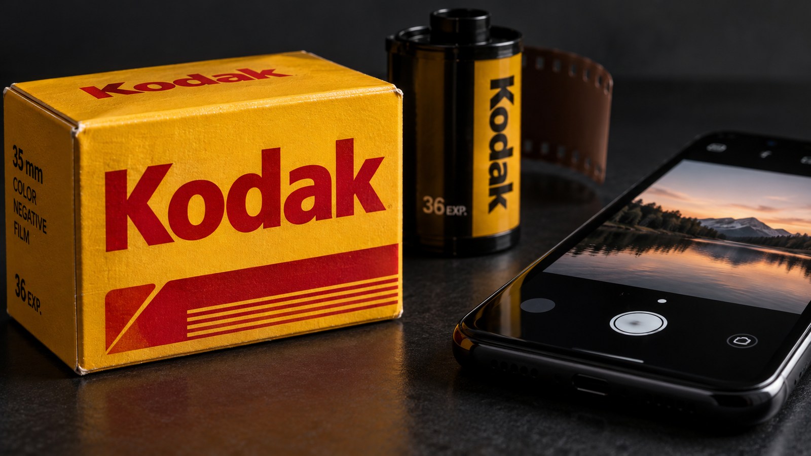 Kodak film packaging and a smartphone camera in a concept still life