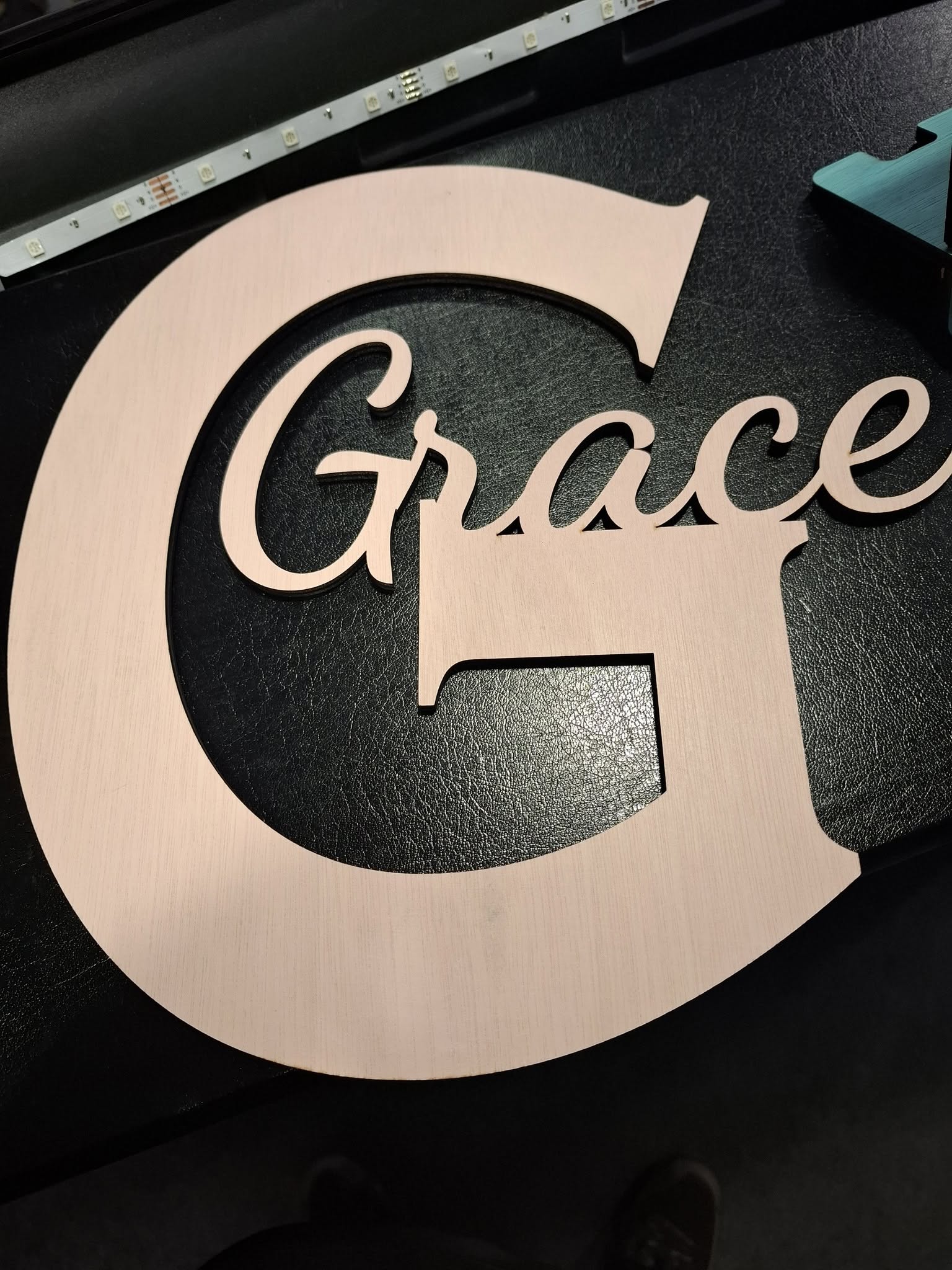Custom cut wooden sign with layered lettering