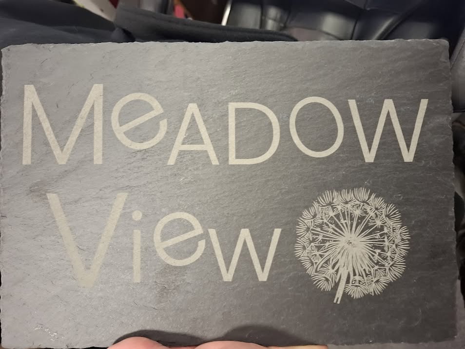 Engraved slate plaque with lettering and dandelion design
