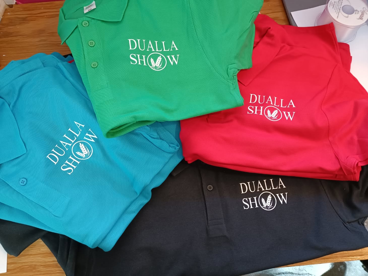Colourful polo shirts printed with the Dualla Show logo by Time for Designs