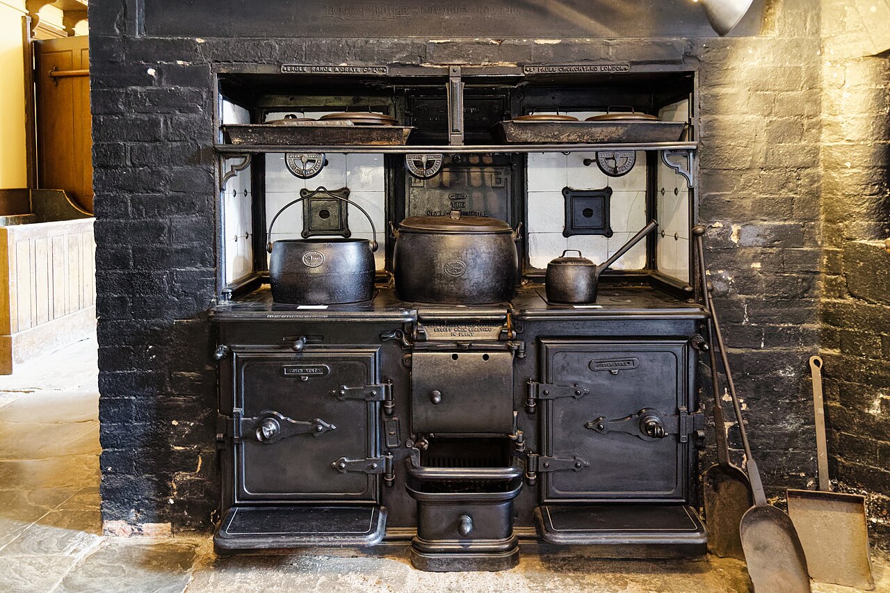 Large cast-iron kitchen range with ovens and hotplates at Charlecote Park in England.