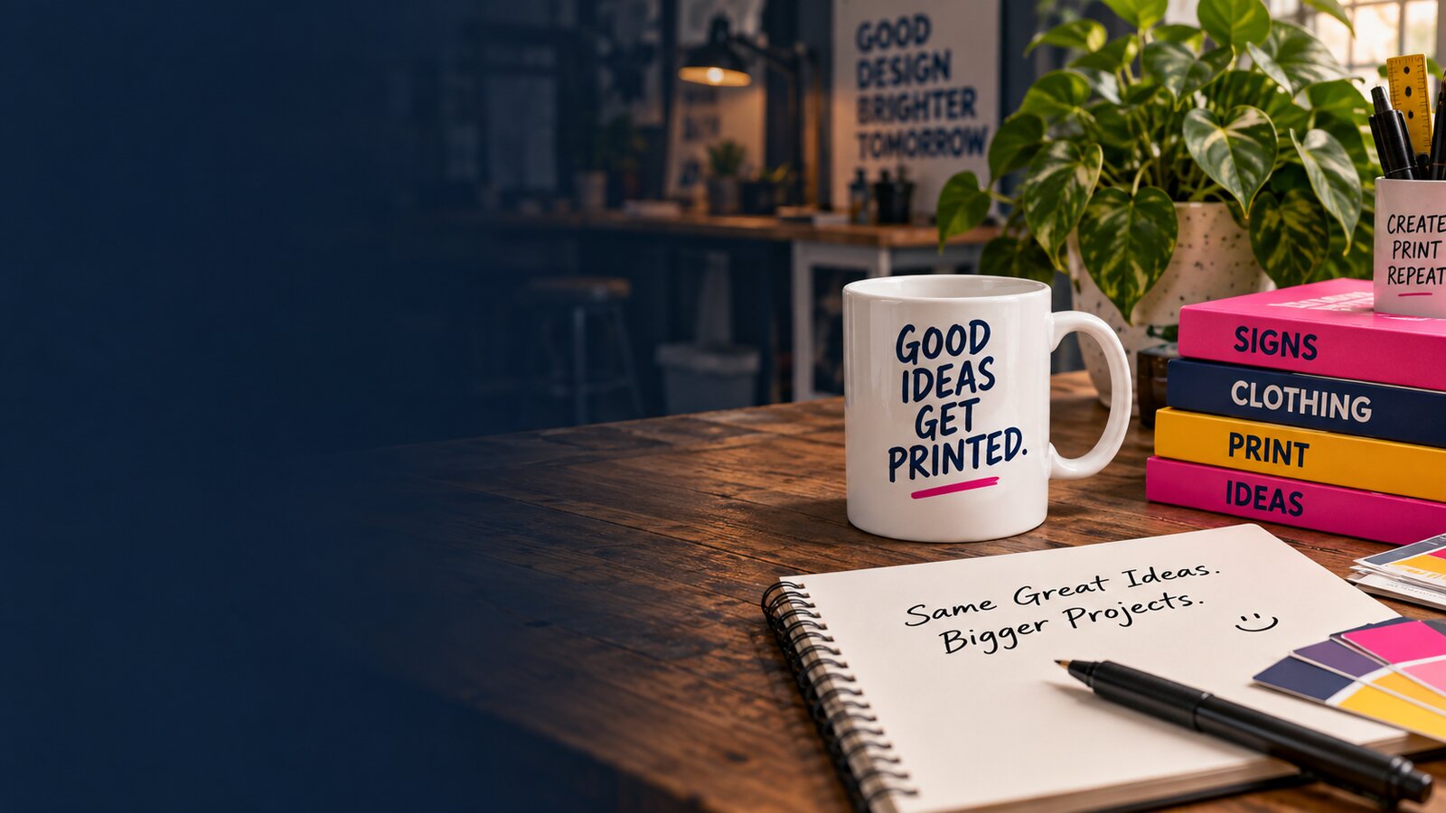 Illustrative creative desk with a printed mug, colourful books and a sketchbook