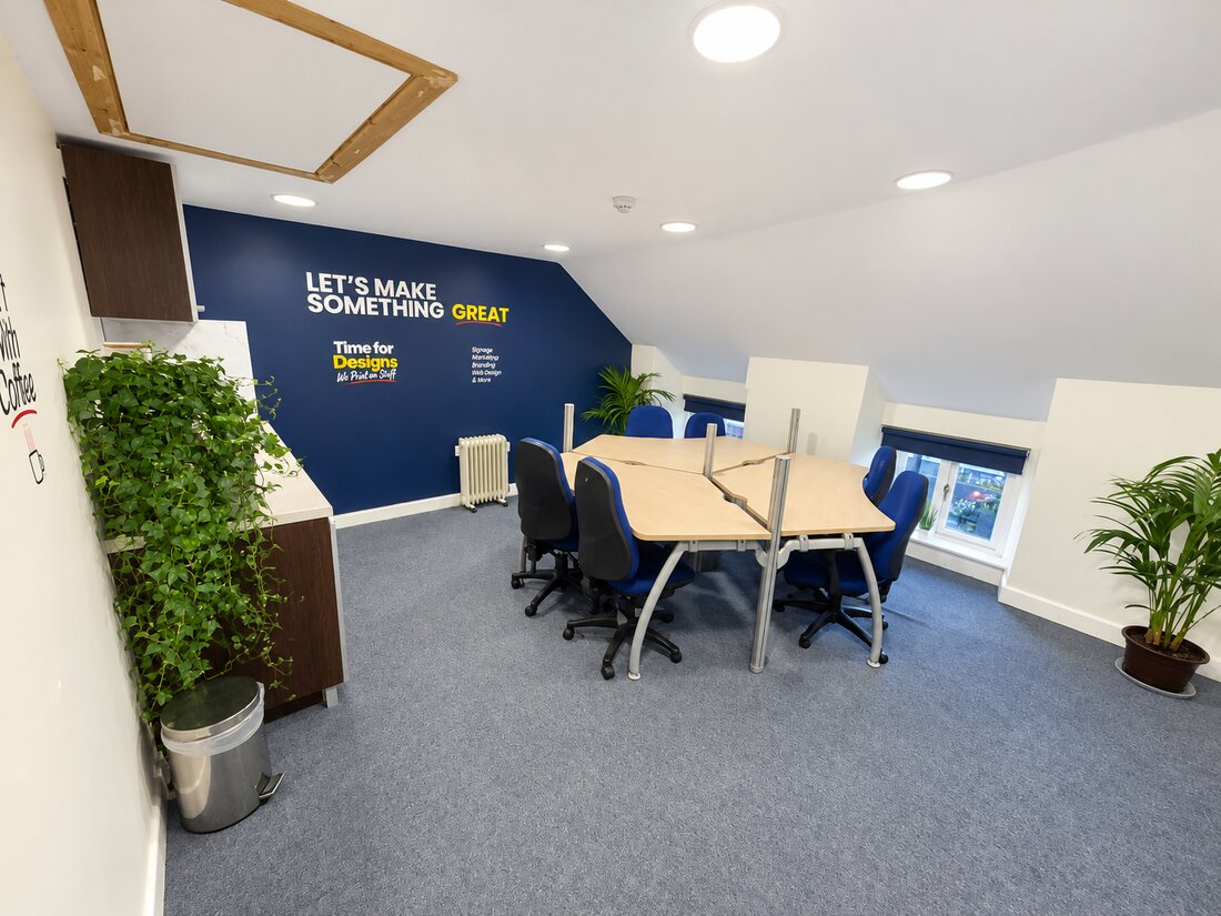 Time for Designs meeting room in Cashel with blue chairs and a navy branded feature wall