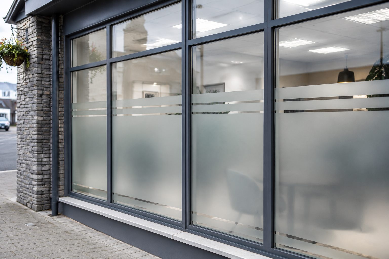 Example showing frosted privacy film with clear bands across office windows