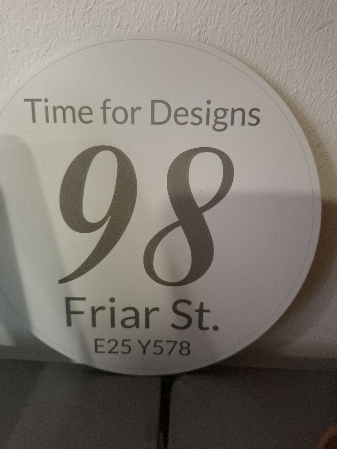 Round personalised house number sign with address and Eircode