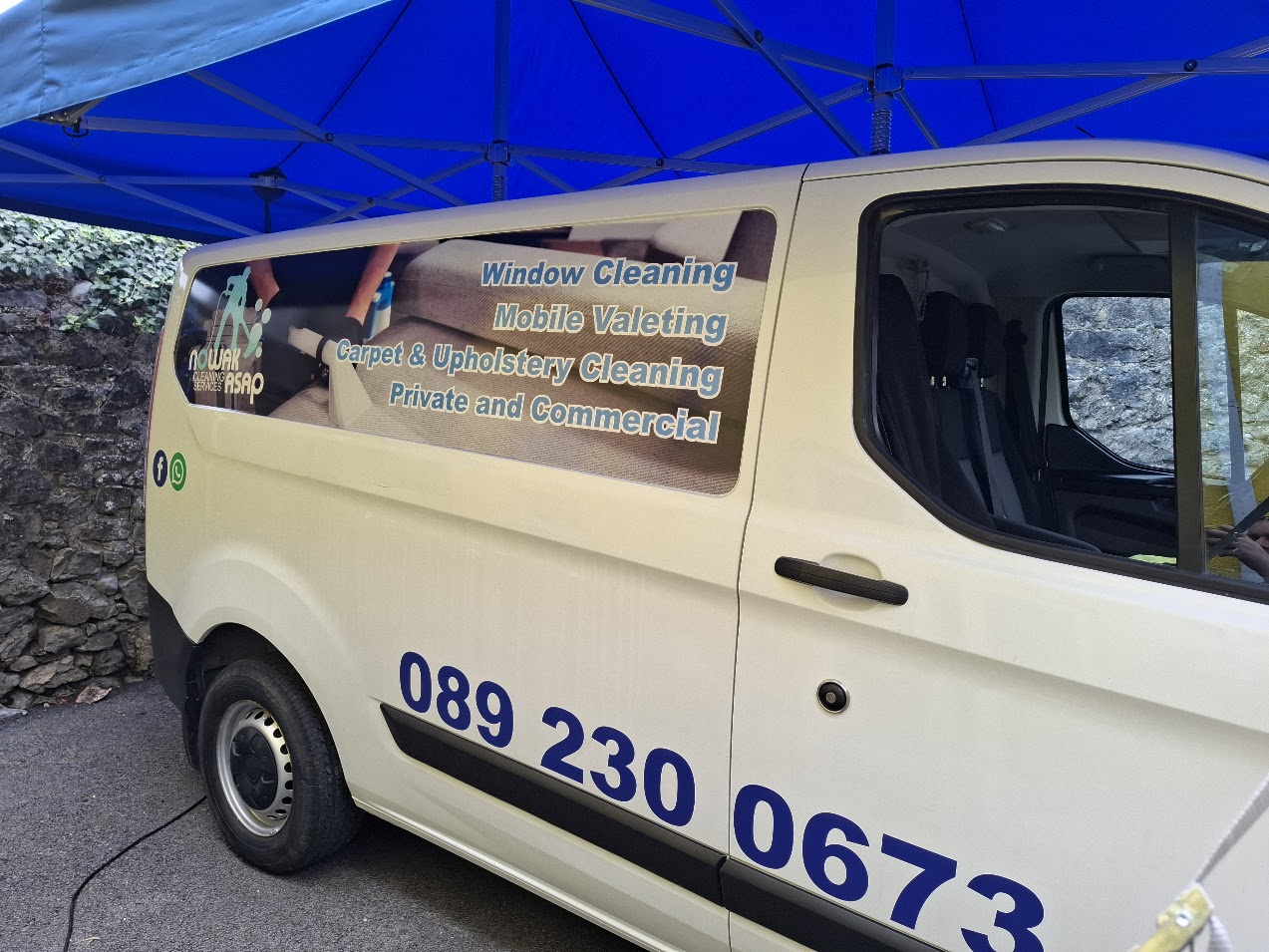 Cleaning business van with a large branded side-panel graphic and contact lettering